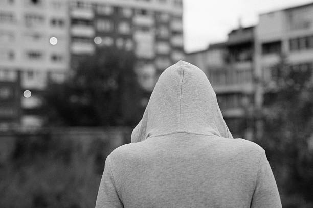 Teen Problems Sad girl standing alone outdoors. turning back stock pictures, royalty-free photos & images