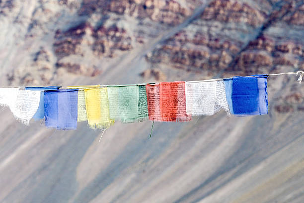 istock Colorful prayer flags with sun shining through prayer flags 611782856