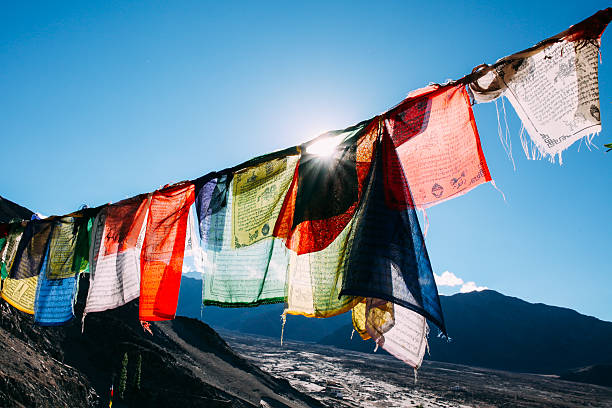 istock Colorful prayer flags with sun shining through prayer flags 611782996