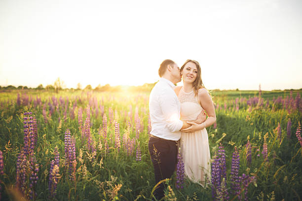 istock Bride holds groom's neck while he kisses her in 611784348