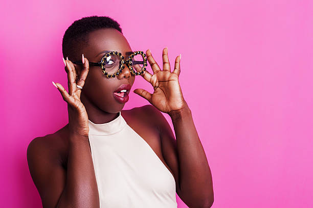 Beautiful african girl portrait wearing funny glasses Beautiful african girl portrait wearing funny glasses skinhead haircut stock pictures, royalty-free photos & images