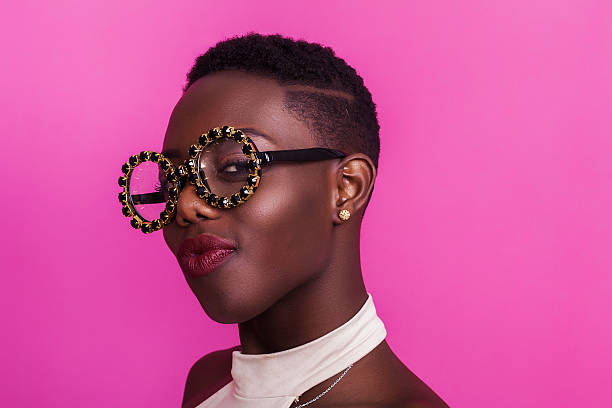 Beautiful african girl portrait wearing odd glasses and smiling Beautiful african girl portrait wearing odd glasses and smiling eccentric stock pictures, royalty-free photos & images