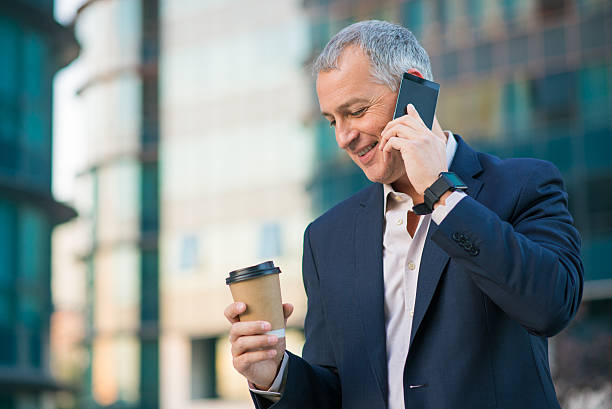 istock Happy Handsome businessman talking on the phone 611785886