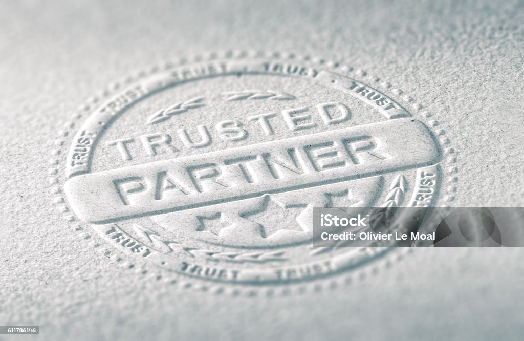 Confidence in Business 3D illustration of an embossed stamp with the text trusted partner, Paper background and blur effect. Concept of confidence in business relationship. Trust Stock Photo