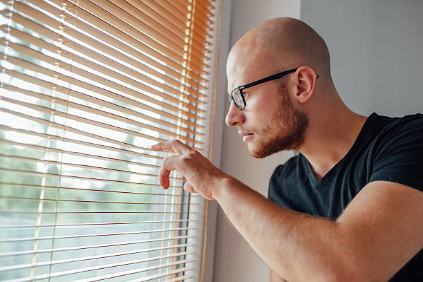 istock Young man is looking out the window. 611788594