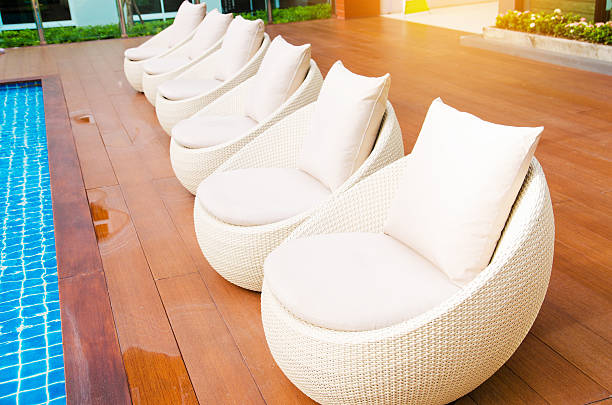 istock rattan chairs with pillows  beside pool 611789018