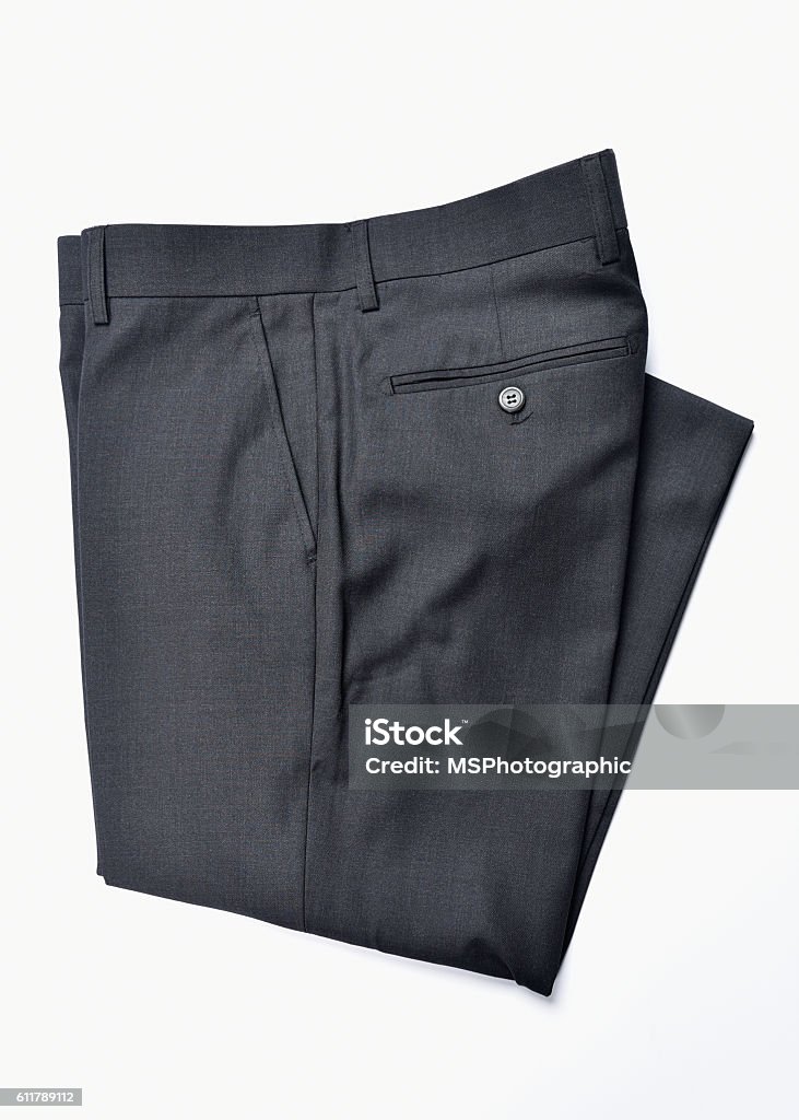 Folded slacks A pair of folded dress slacks on a white background Pants Stock Photo