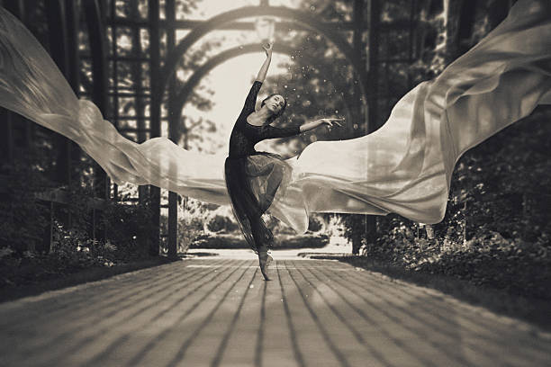 Ballerina on the streets Ballerina out of doors, young modern ballet dancer posing. Black and white photography. The fabric in the air theatrical performance photos stock pictures, royalty-free photos & images