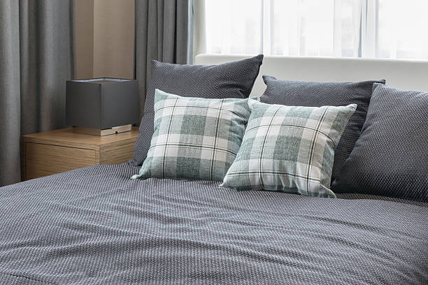 istock bedroom interior design with checked green pillows on grey bed 611790908