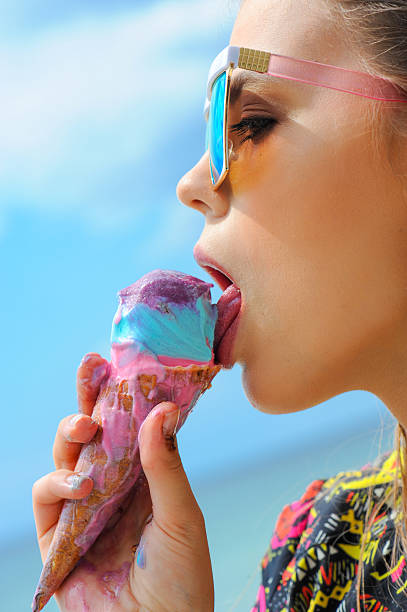Young real woman eating ice cream