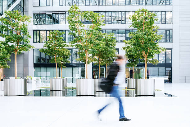 istock blurred business man walking in a business park 611856924