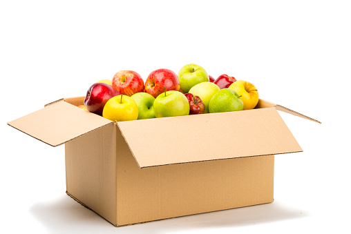 Different apples, green, yellow and red, into a carton box ready to send or storage.