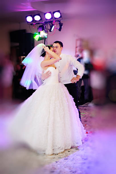 istock groom and bride dancing in restaurant 611858874