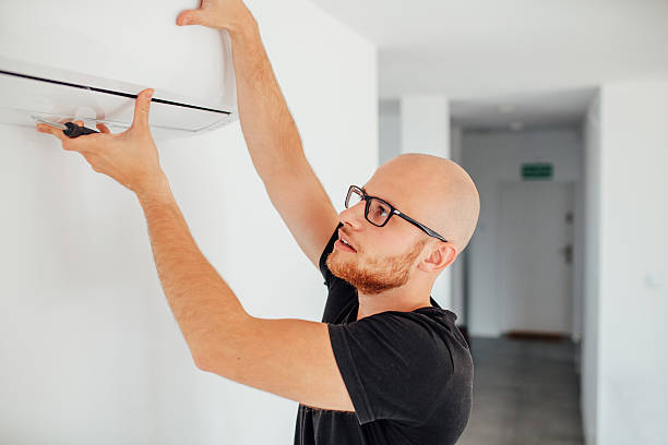 Man is repairing an air condition. Home background stock photo