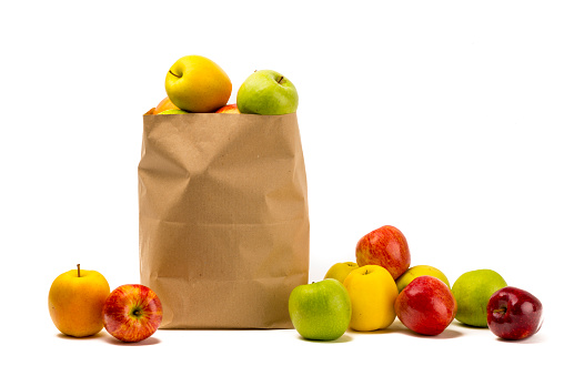 Different apples, green, yellow and red, into a carton bag ready to send or storage.