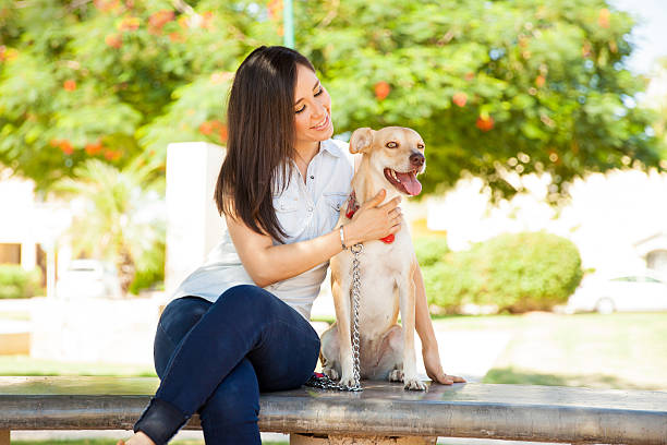 istock Cute girl petting her dog 611859340