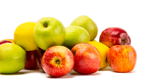 Different apples, green, yellow and red, into a carton bag ready to send or storage.