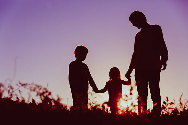 istock father with son and daughter walk at sunset 611859568