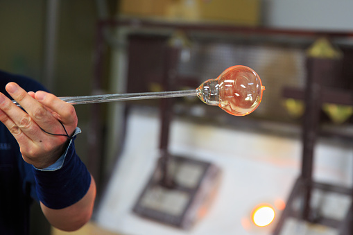 Blowing air into heated glass to create wind bell