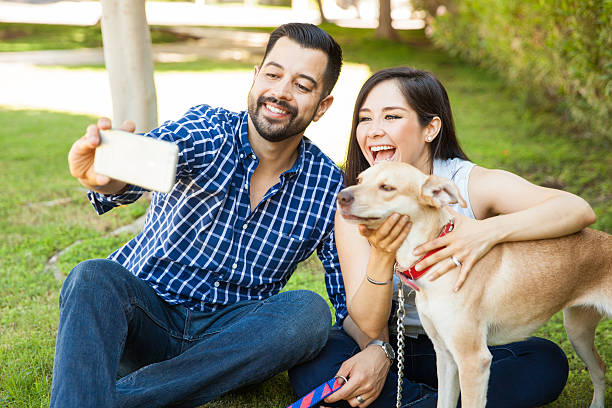 istock Couple taking selfie with their dog 611861188