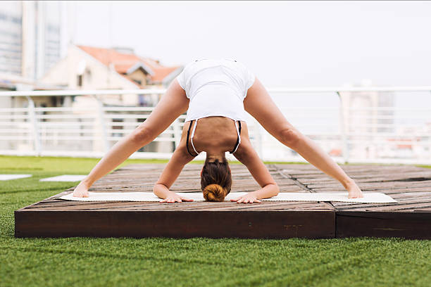 istock Beautiful woman doing yoga outdoors on a rooftop terrace 611861208