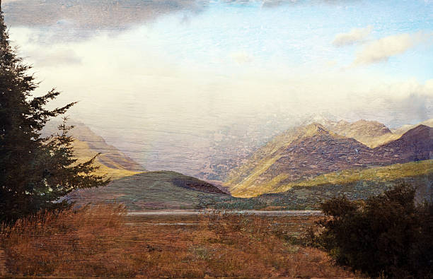 istock Grunge textured meadow, mountains and lake 611862442
