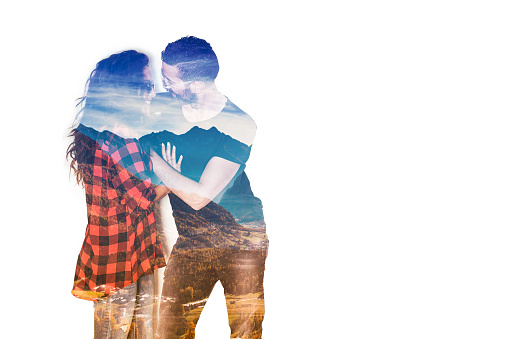 Double exposure of beautiful couple smiling and mountainscape