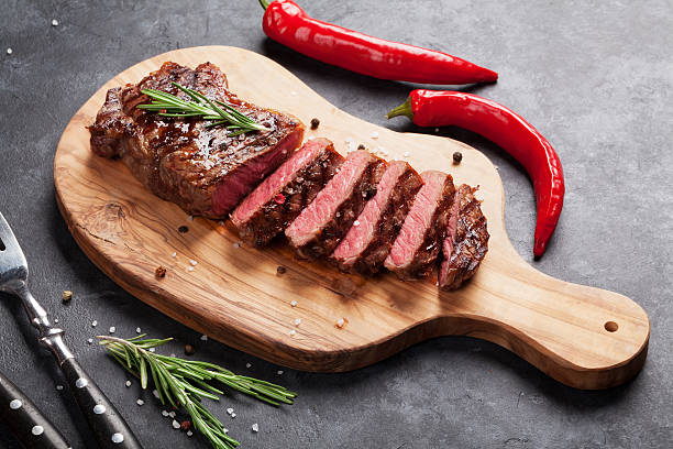 Grilled sliced beef steak Grilled sliced beef steak on cutting board over stone table roast dinner photos stock pictures, royalty-free photos & images