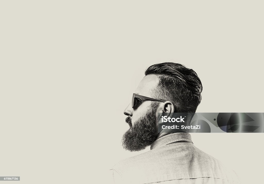 Bearded man with glasses Black and white portrait of a Bearded Man in a denim shirt and glasses  on toned background. There is a spase for your text. Men Stock Photo