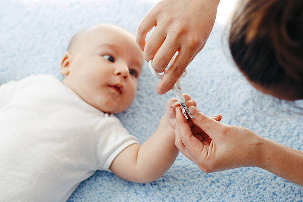 istock Mother cutting babies nails 611867504