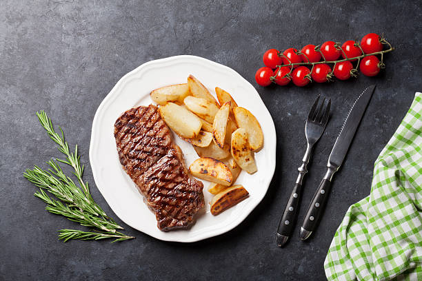 istock Grilled striploin steak and roasted potato 611867590