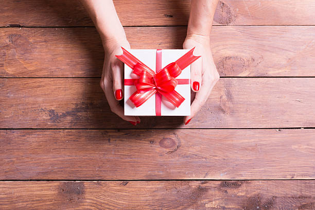 istock Woman holding a christmas gift 611868430