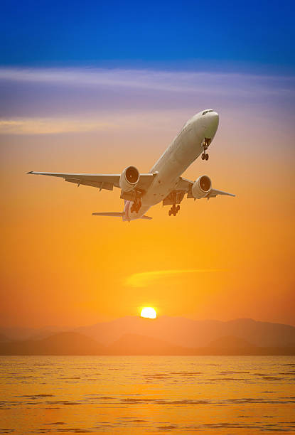 istock Plane flying above mountain at during sunset. 611868518