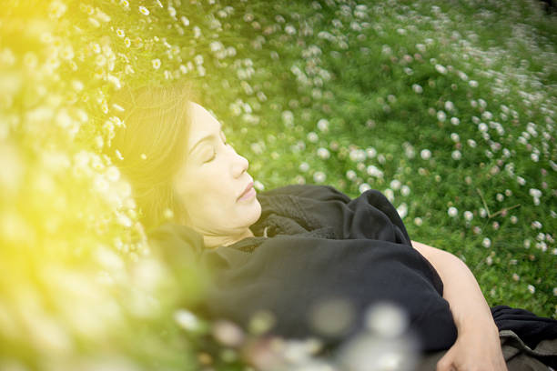 Casual woman relaxing lying on the grass