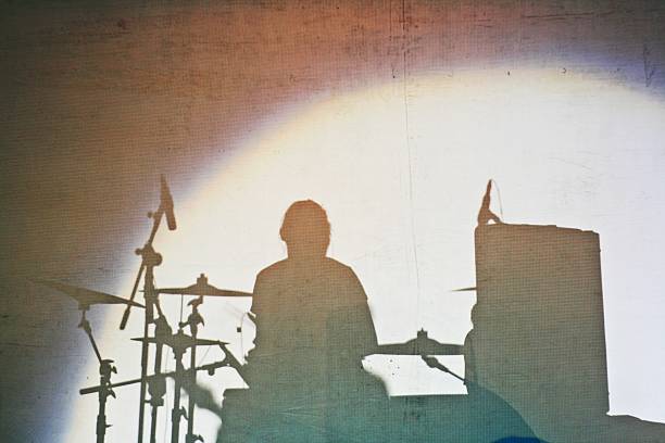 istock shadow of woman playing drum 611875428