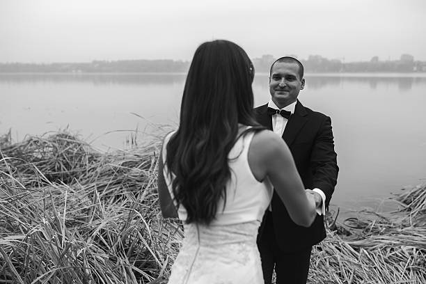 istock Wedding couple at the lake shore 611877110