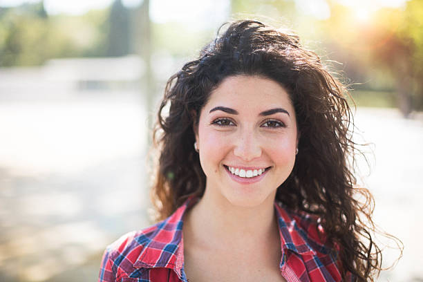 istock Young woman looking at camera and smiling. 611877174
