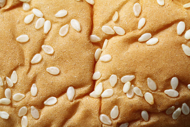 istock Macro image of sesame seeds on bread bun 611879640