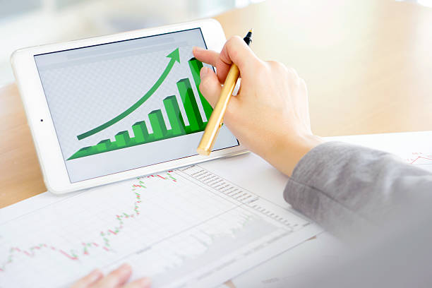 istock Hand on screen tablet pc with business information 611880056