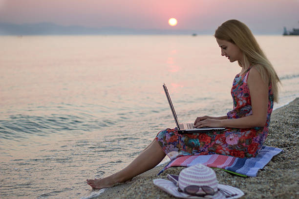 istock Woman chatting on beach at Sunrise 611880160