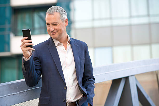 istock Confident smiling businessman talking on his smartphone 611880694