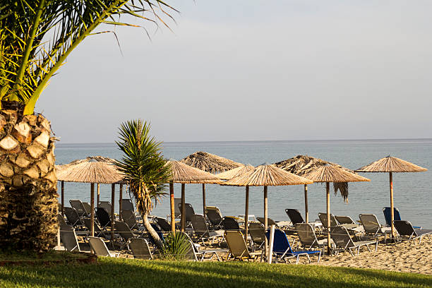 istock Summer with Loungers and umbrella on tropical beach 611881084