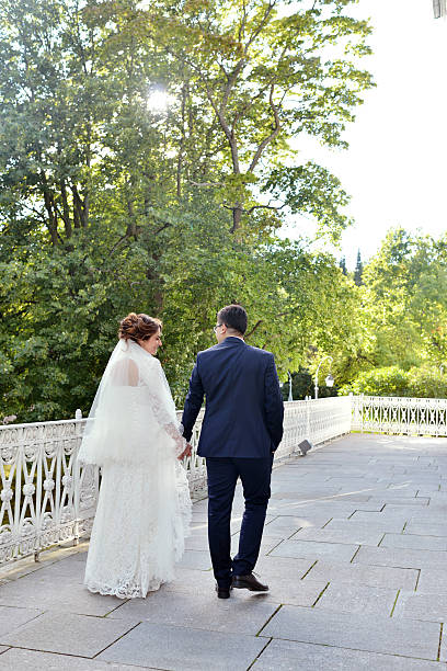 istock Wedding couple on the nature is walking 611881308