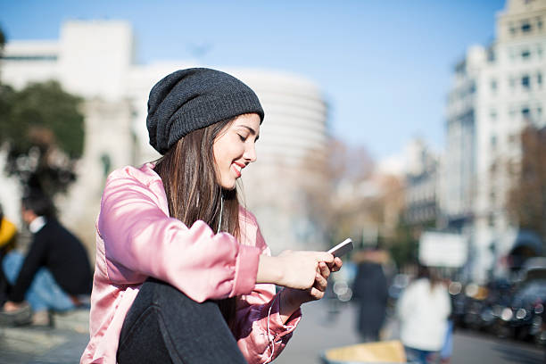istock Young woman with smart phone in Barcelona, technology. 611882652