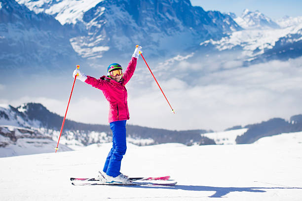 istock Young active woman skiing in the mountains. 611882716