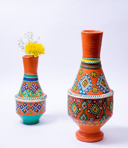 istock Two colorful pottery vases with yellow flower on white background 611883818
