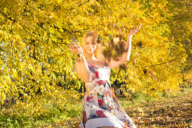 istock Beautiful woman in autumn park 611884804