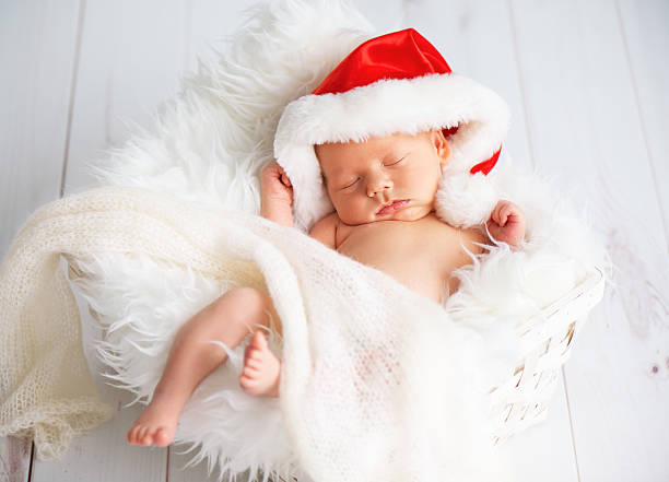 istock sleeper newborn baby in  Christmas Santa cap 611884946