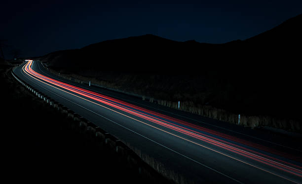 istock Light trails from fast moving cars 611885072