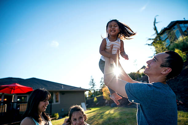 istock Ethnic father holding his daughter in the air 611886416